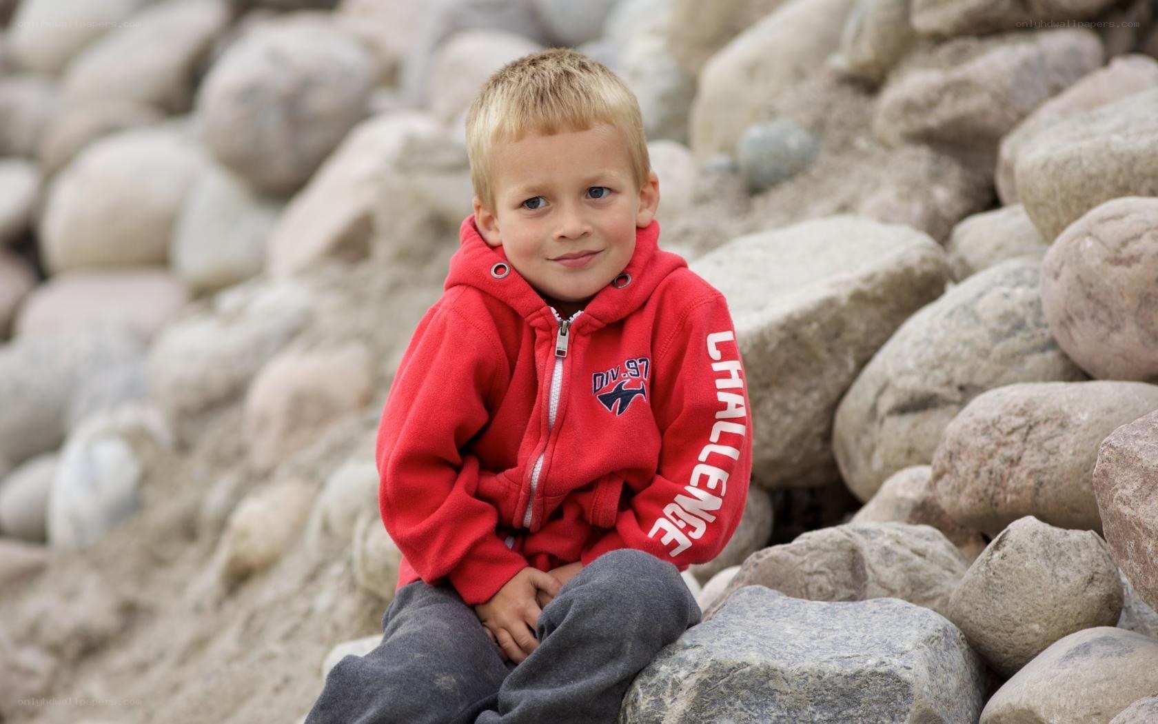 Boy in red hoodie on rocks