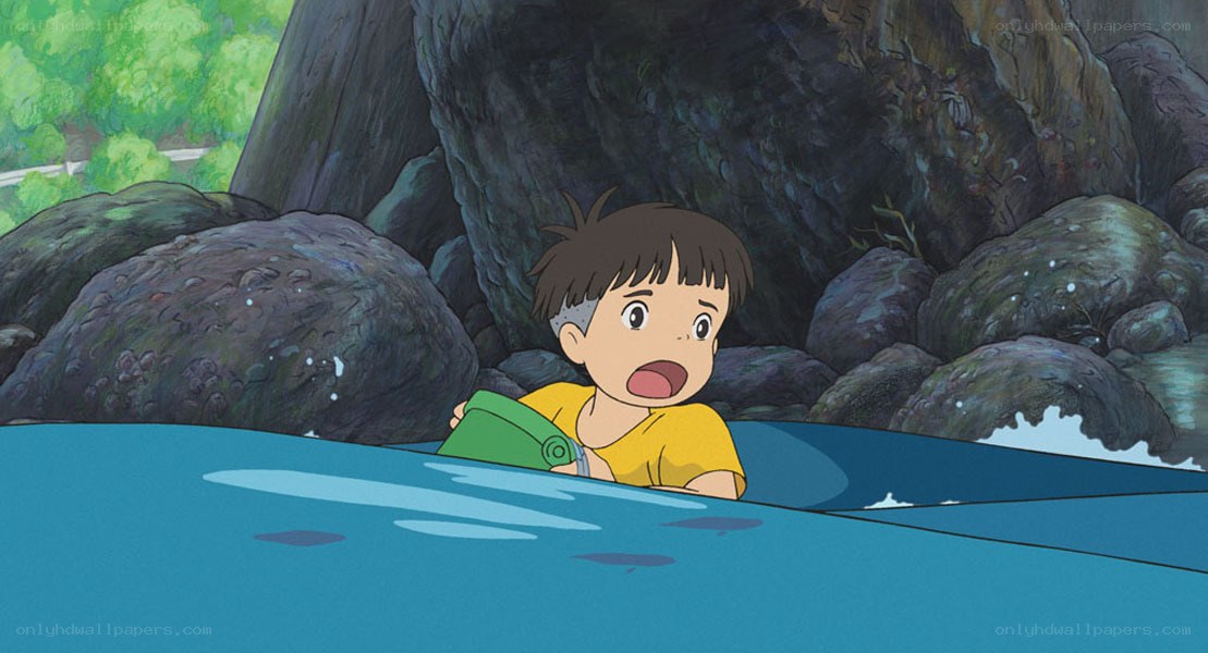 boy in water holding green object