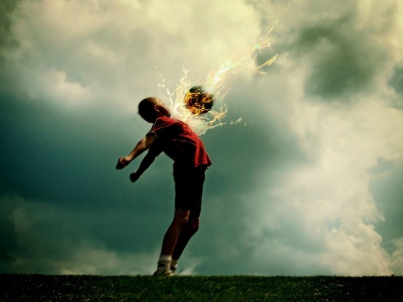 Boy kicking flaming ball