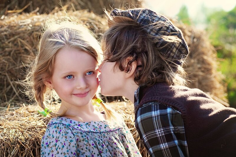 Boy Kissing Girl on Cheek — Brown