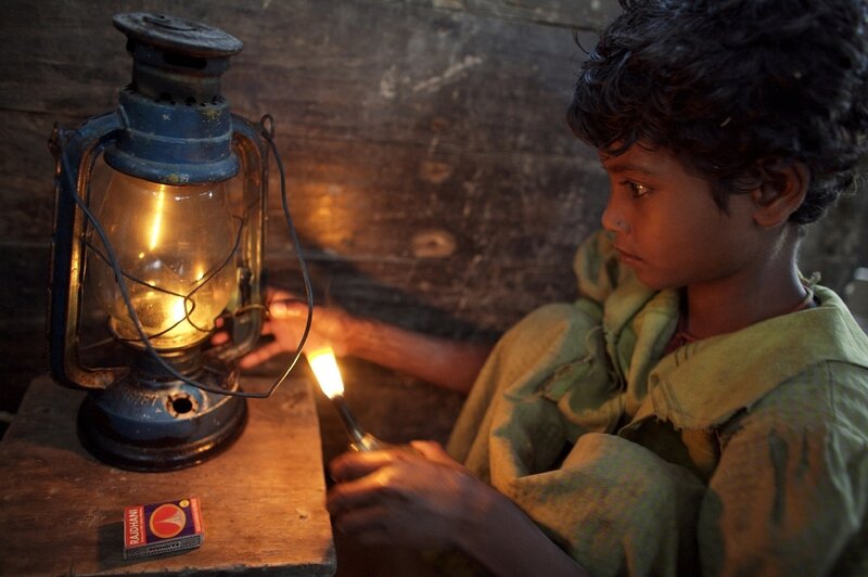 Boy Lighting a Lantern