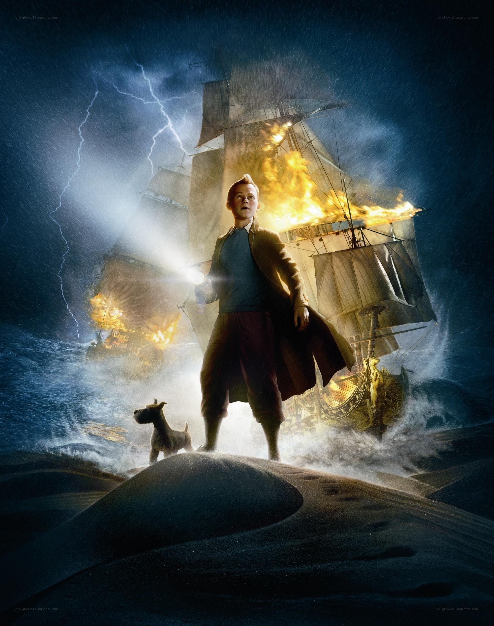 boy on a sand dune with burning ship