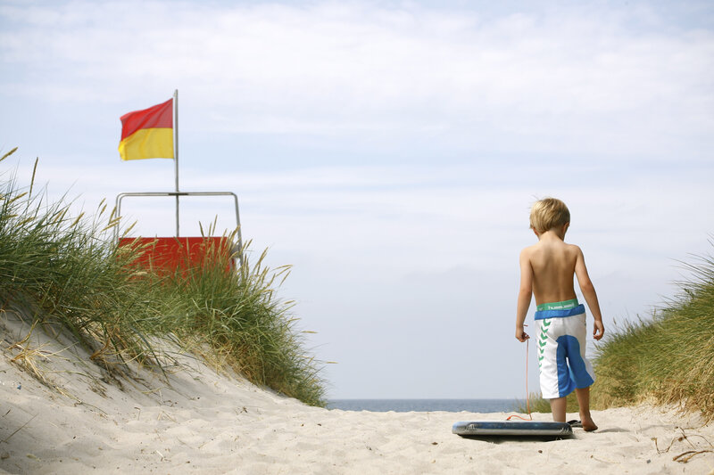 Boy on Beach with Boogie Board