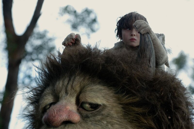 boy on creature's shoulders