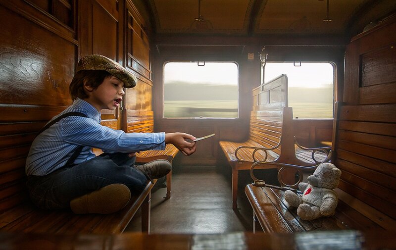 Boy on Train with Teddy Bear
