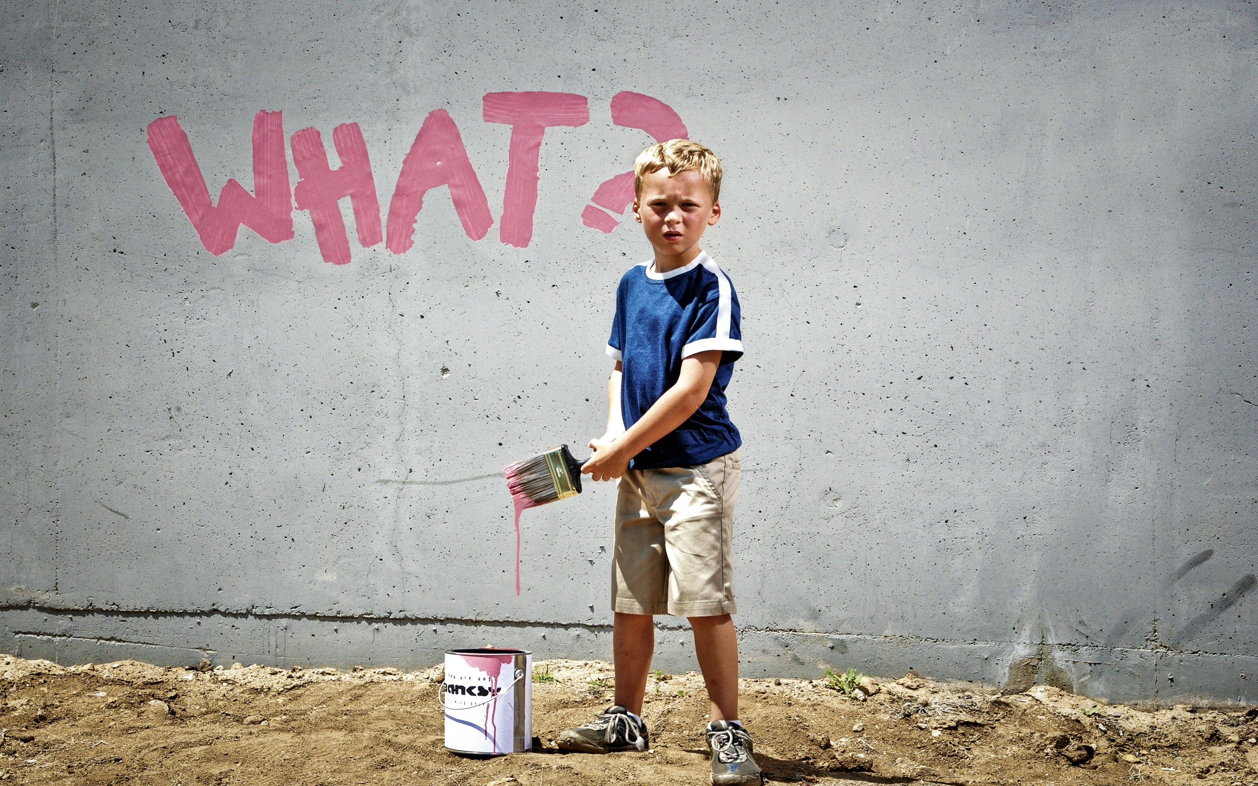 Boy painting on a wall