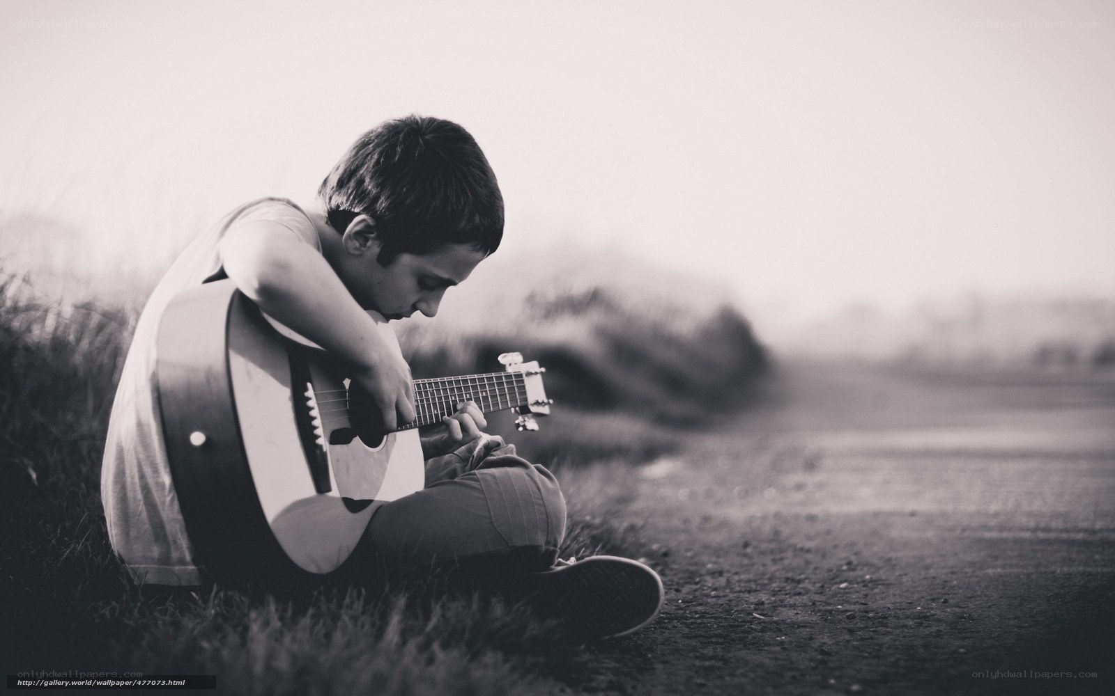boy playing guitar outdoors