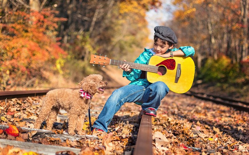Boy Playing Guitar with Dog