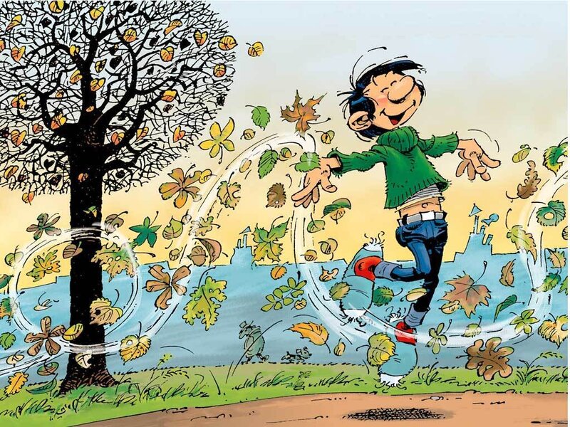 boy playing in autumn leaves