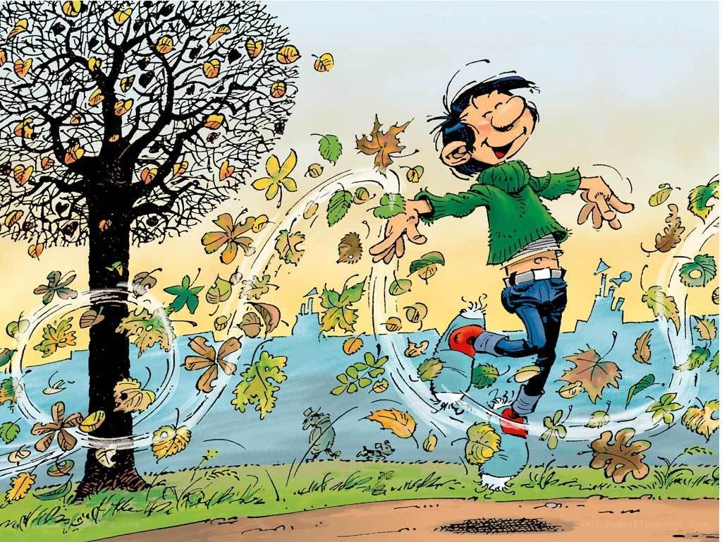 boy playing in autumn leaves