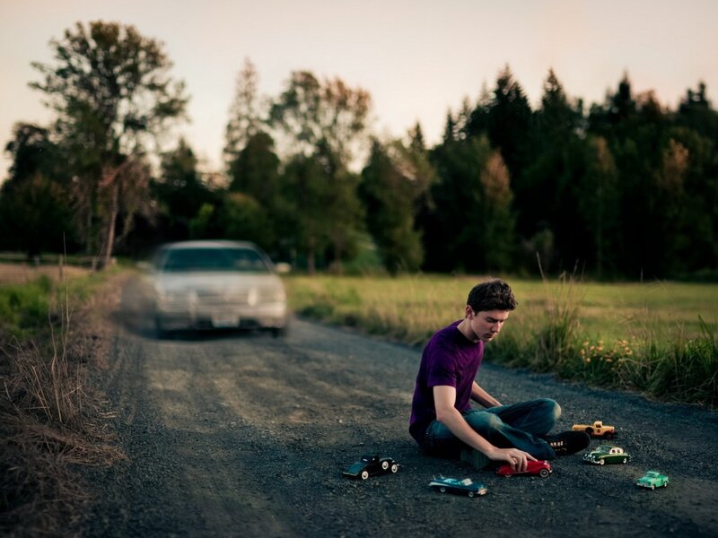 Boy Playing with Toy Cars
