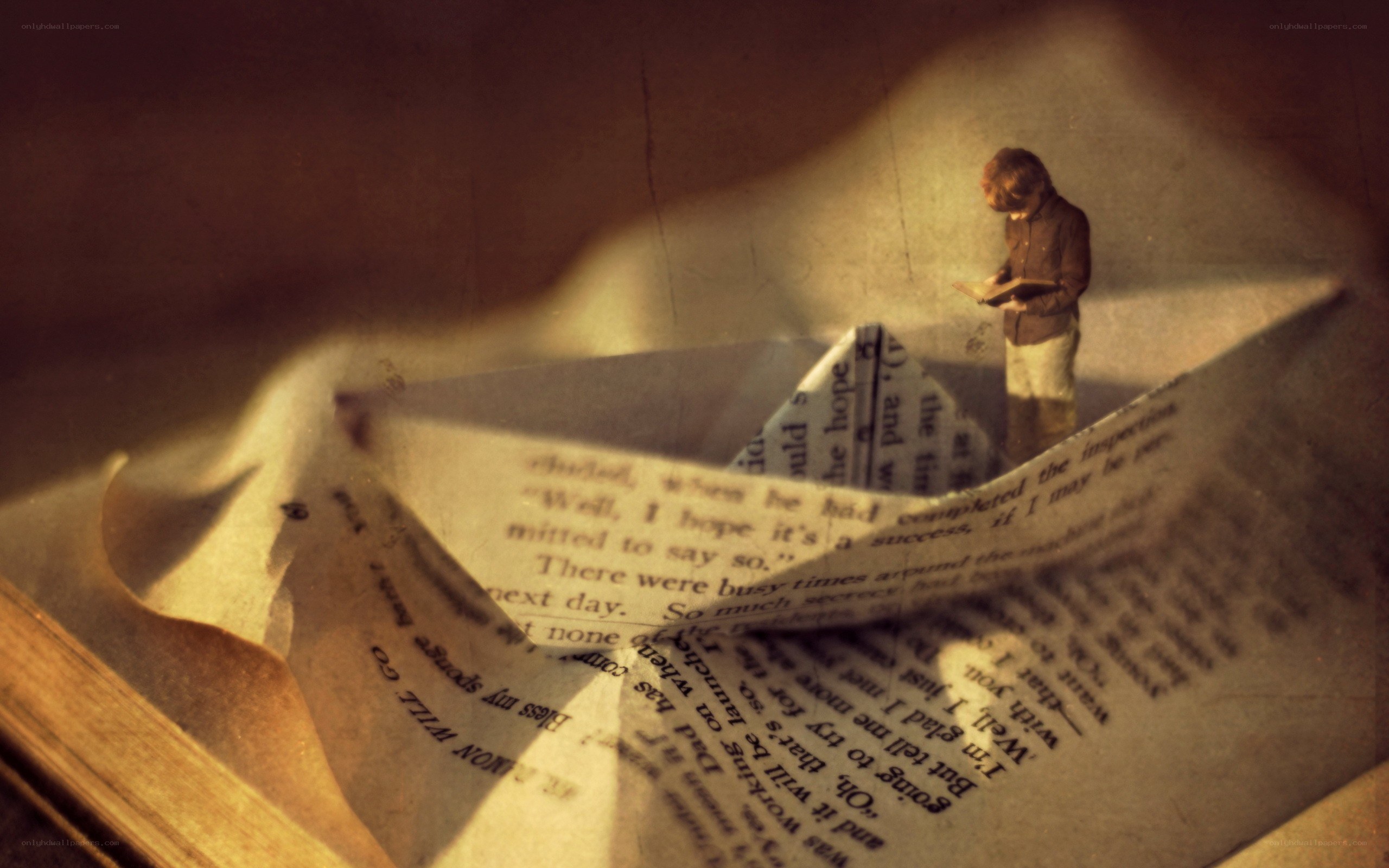 Boy reading on a paper boat