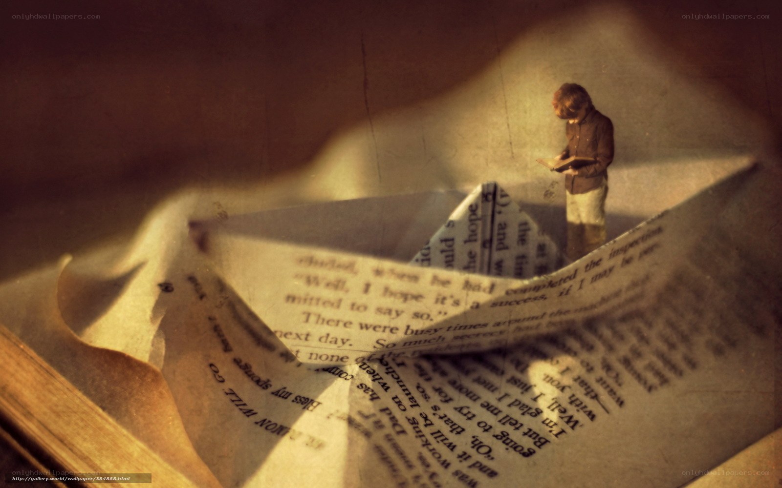 Boy reading on paper boat