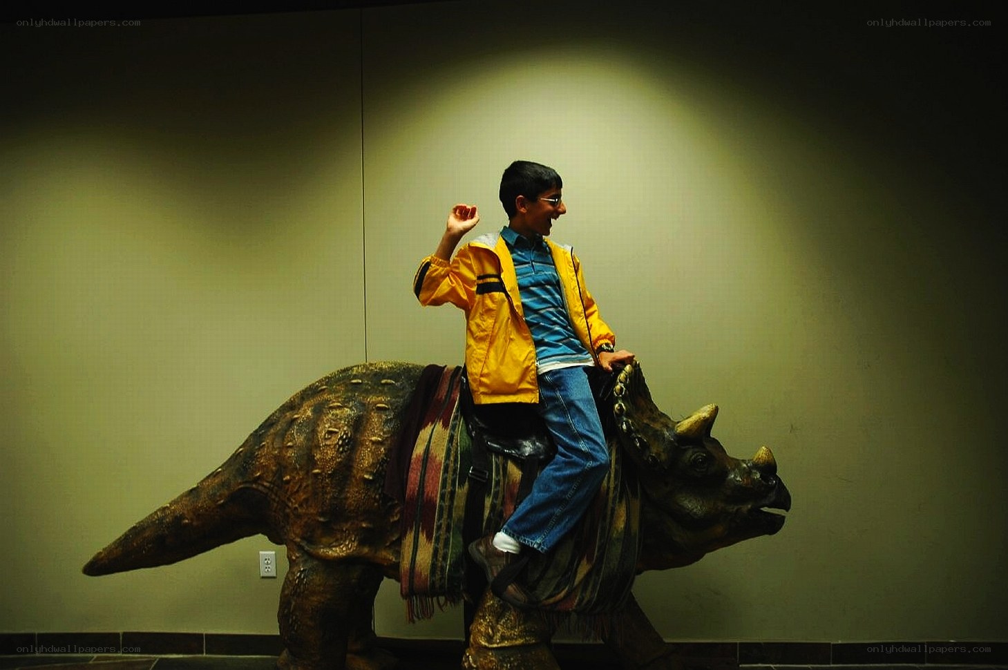 Boy riding dinosaur statue