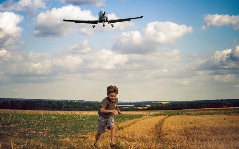 Boy Running in Field — Blue, Serene