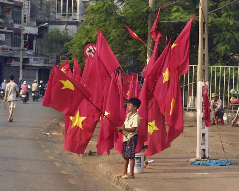 Boy selling flags on street