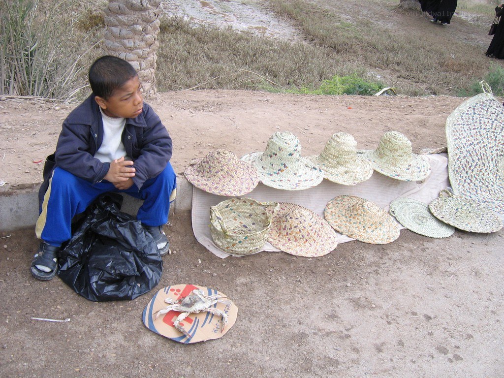 Boy selling straw hats