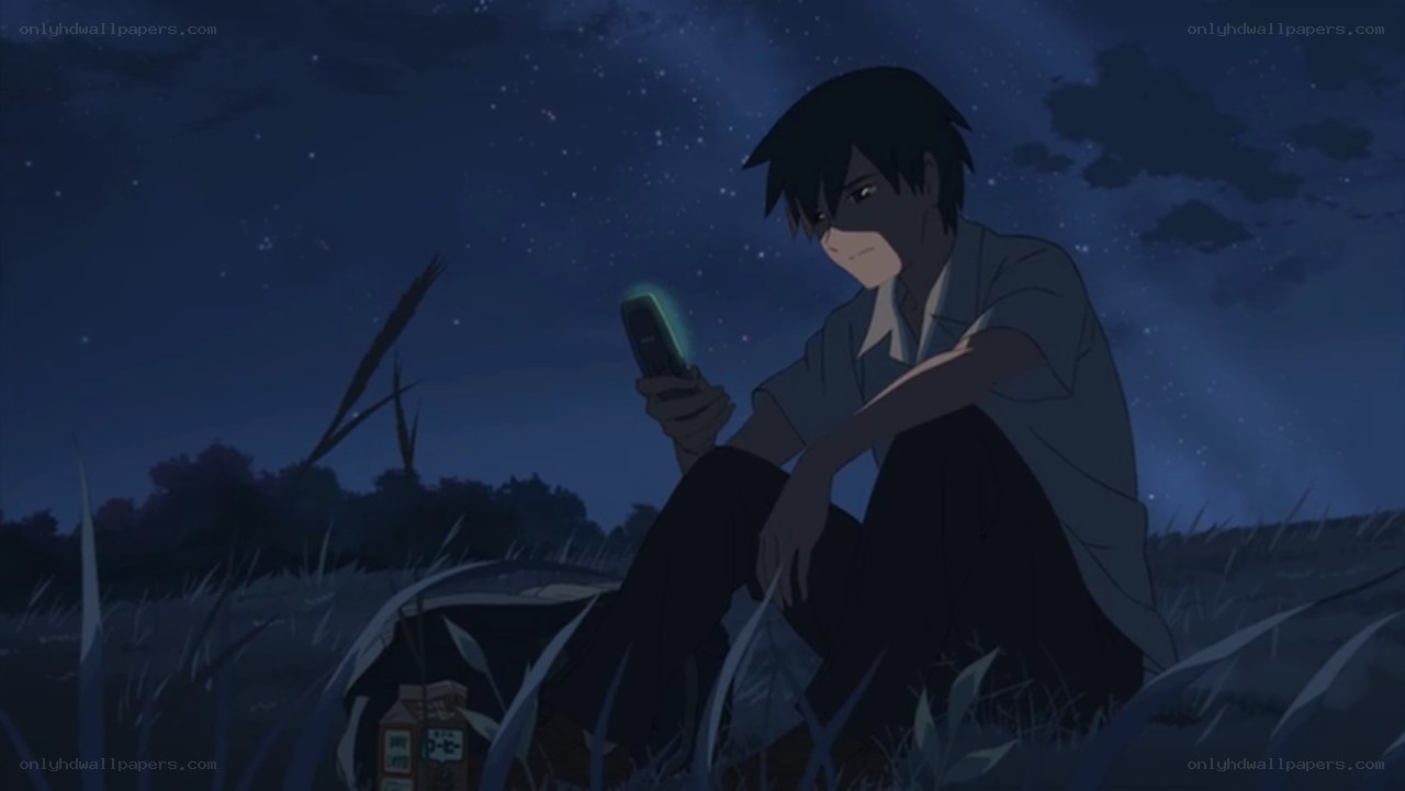 boy sitting in field at night
