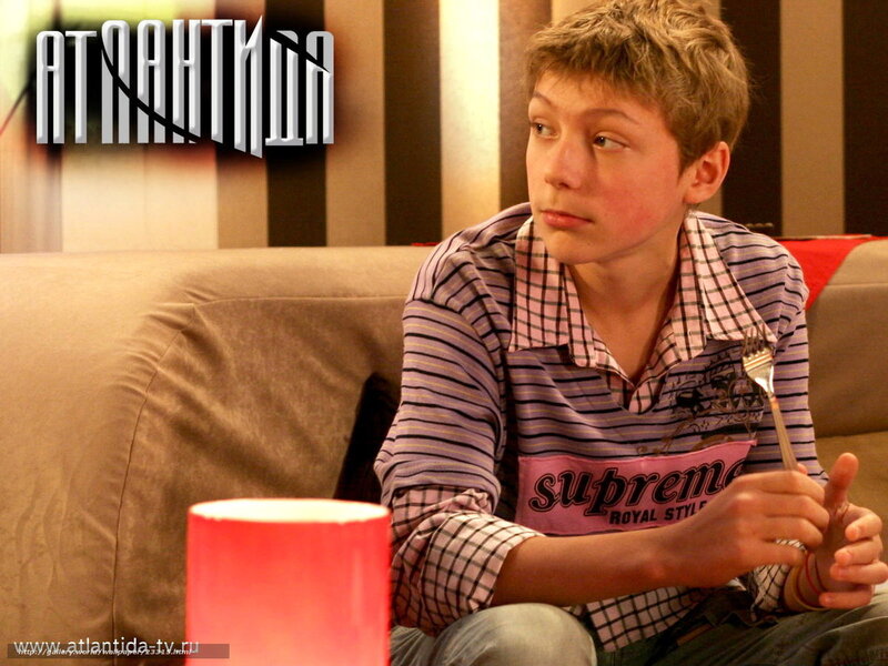 boy sitting on couch holding fork
