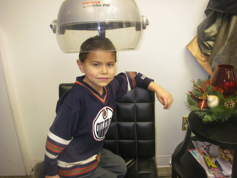 Boy under hair dryer