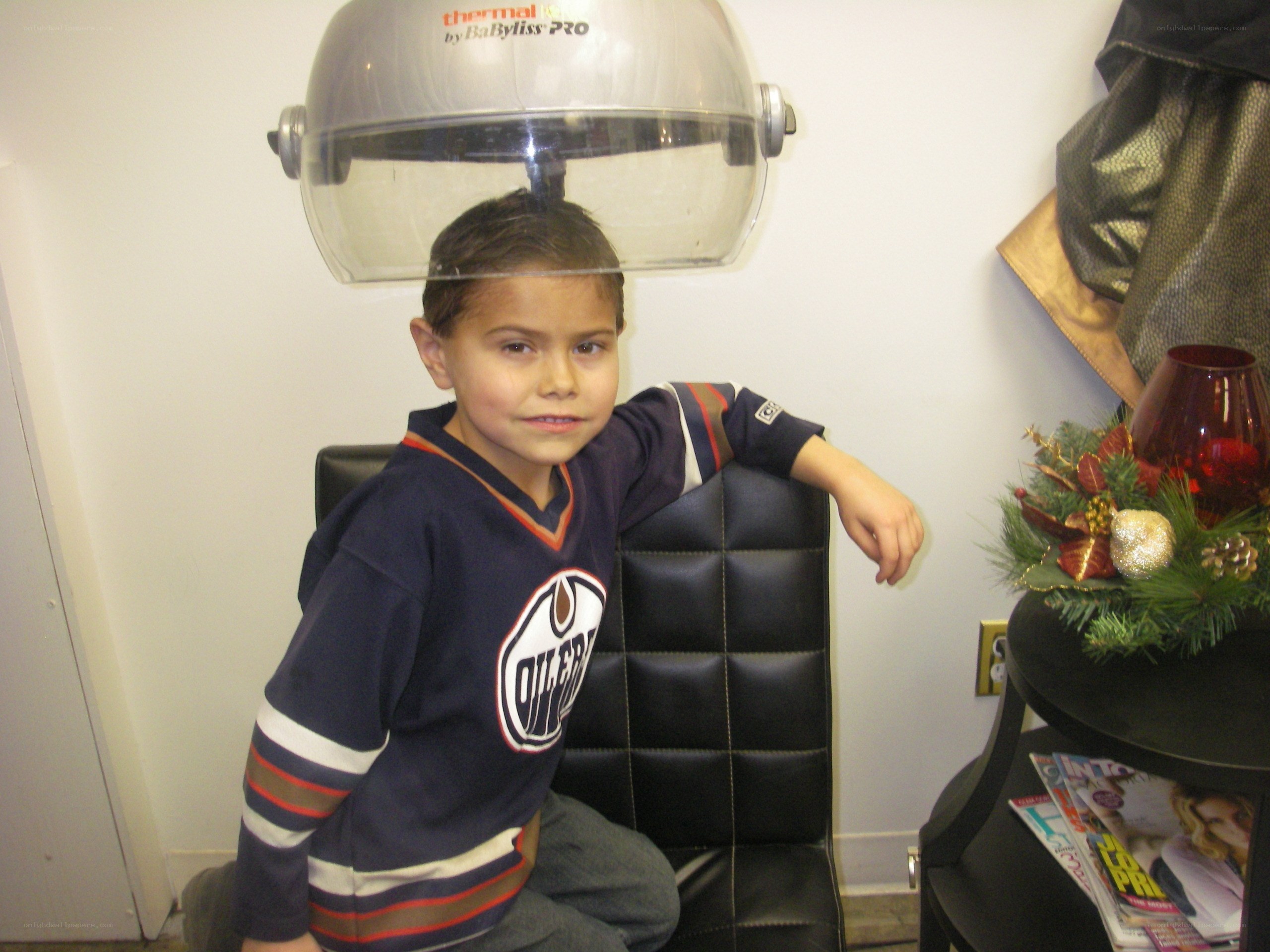 Boy under hair dryer