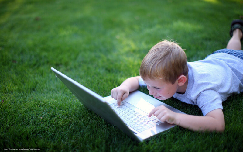 Boy Using Laptop on Grass