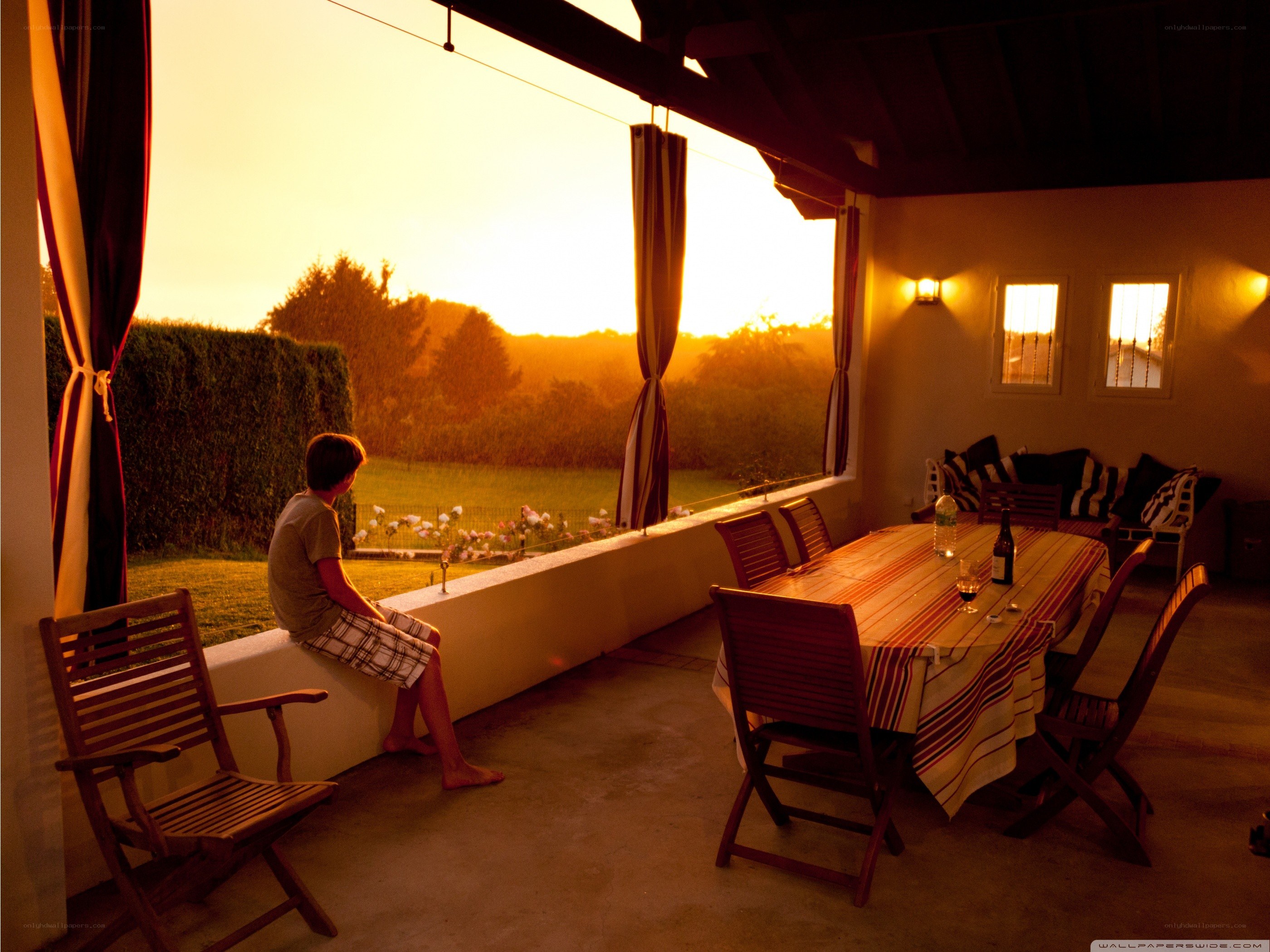 Boy watching sunset on patio