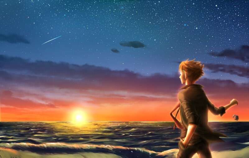 Boy watching sunset over ocean