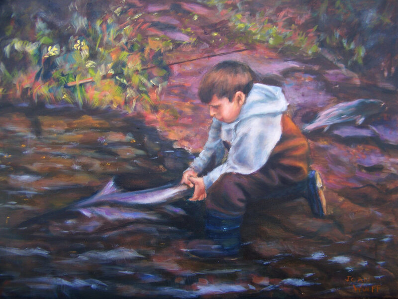 Boy with fish in stream