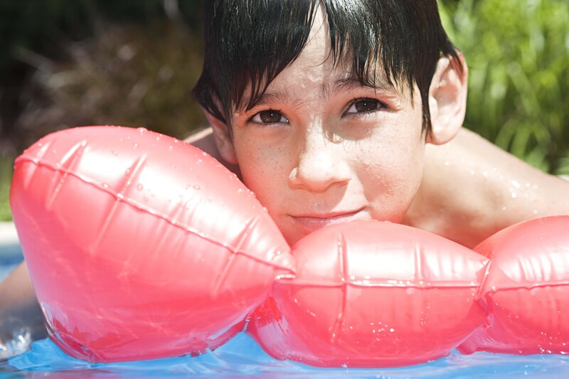 boy with floaties in pool