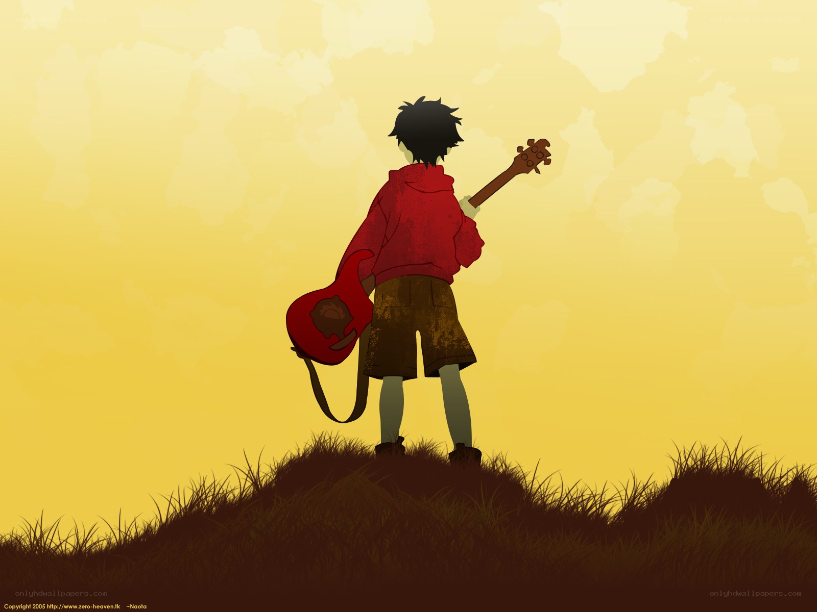 boy with guitar on hill