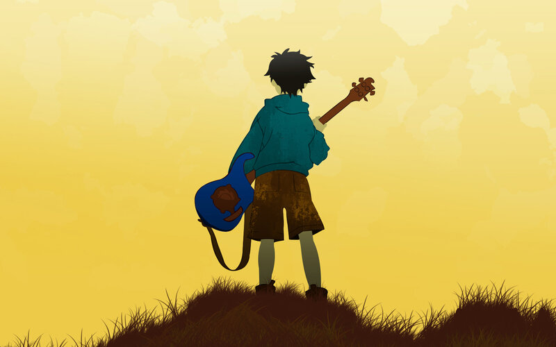 boy with guitar on hill