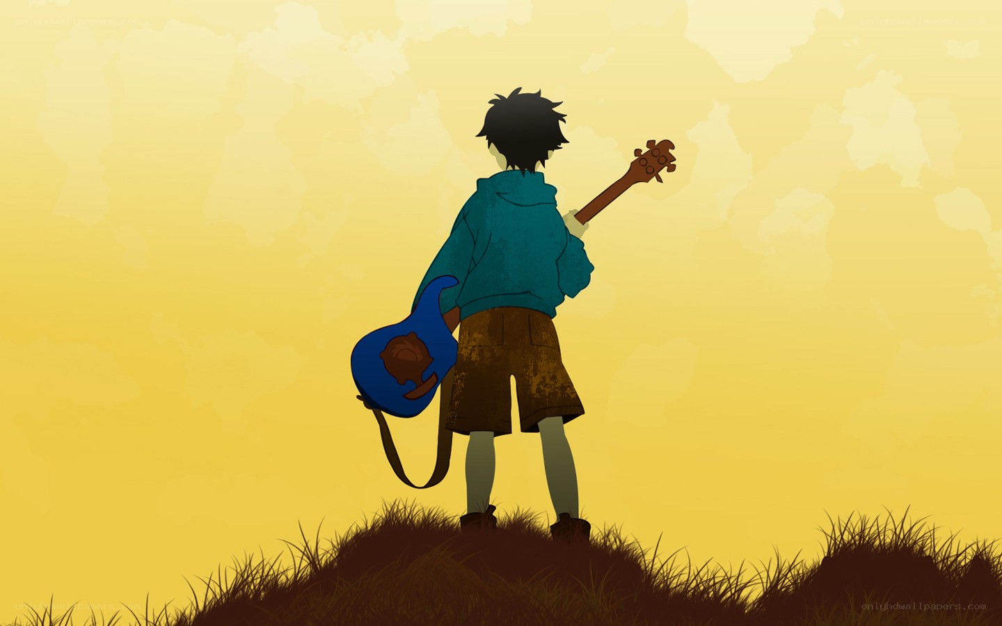 boy with guitar on hill