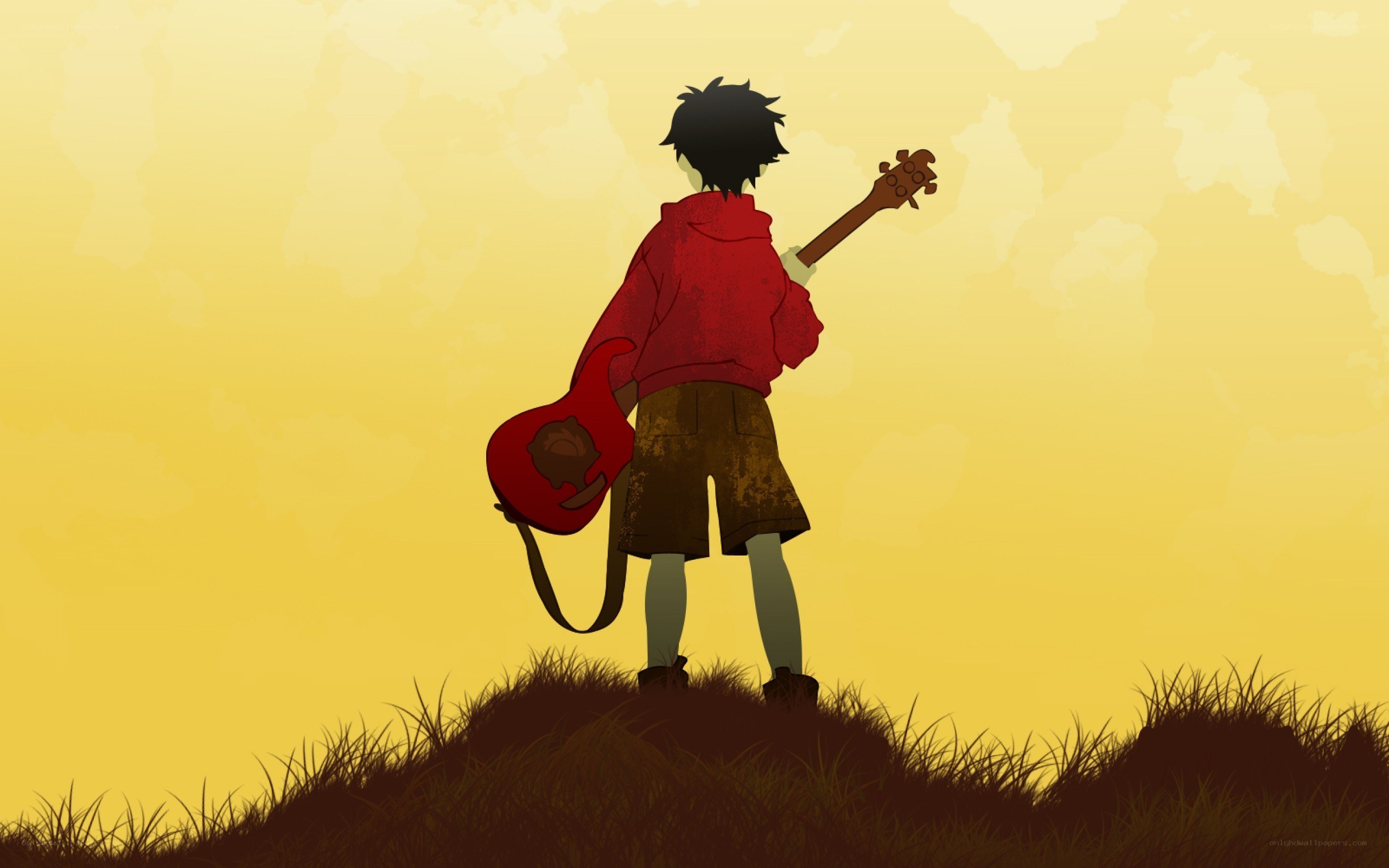boy with guitar on hill
