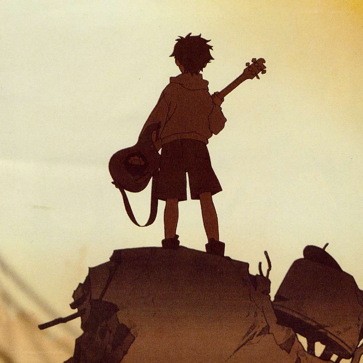 boy with guitar on rock