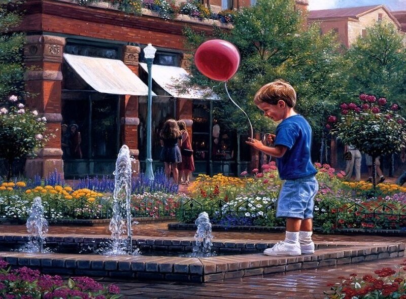 Boy with red balloon in town square