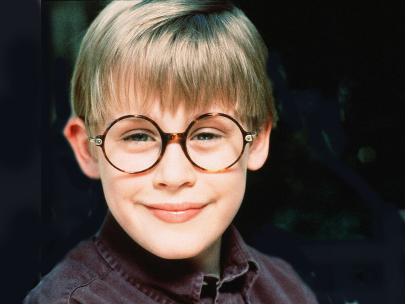 boy with round glasses smiling