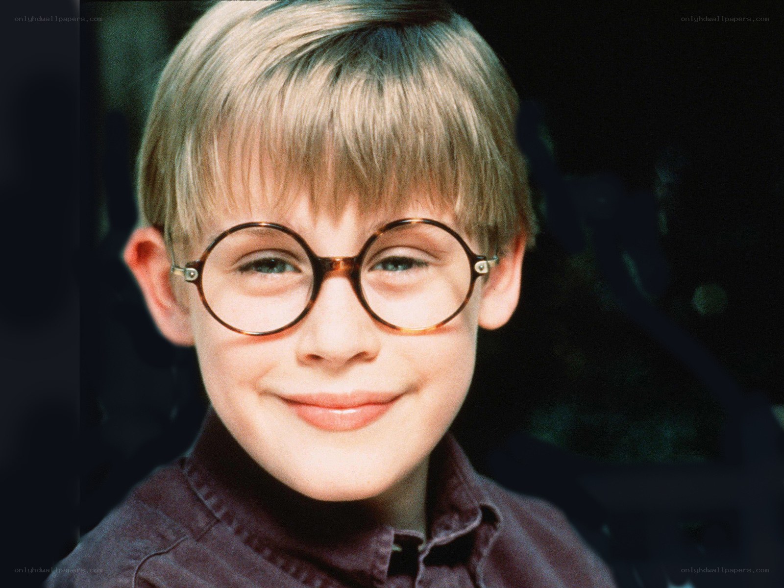boy with round glasses smiling