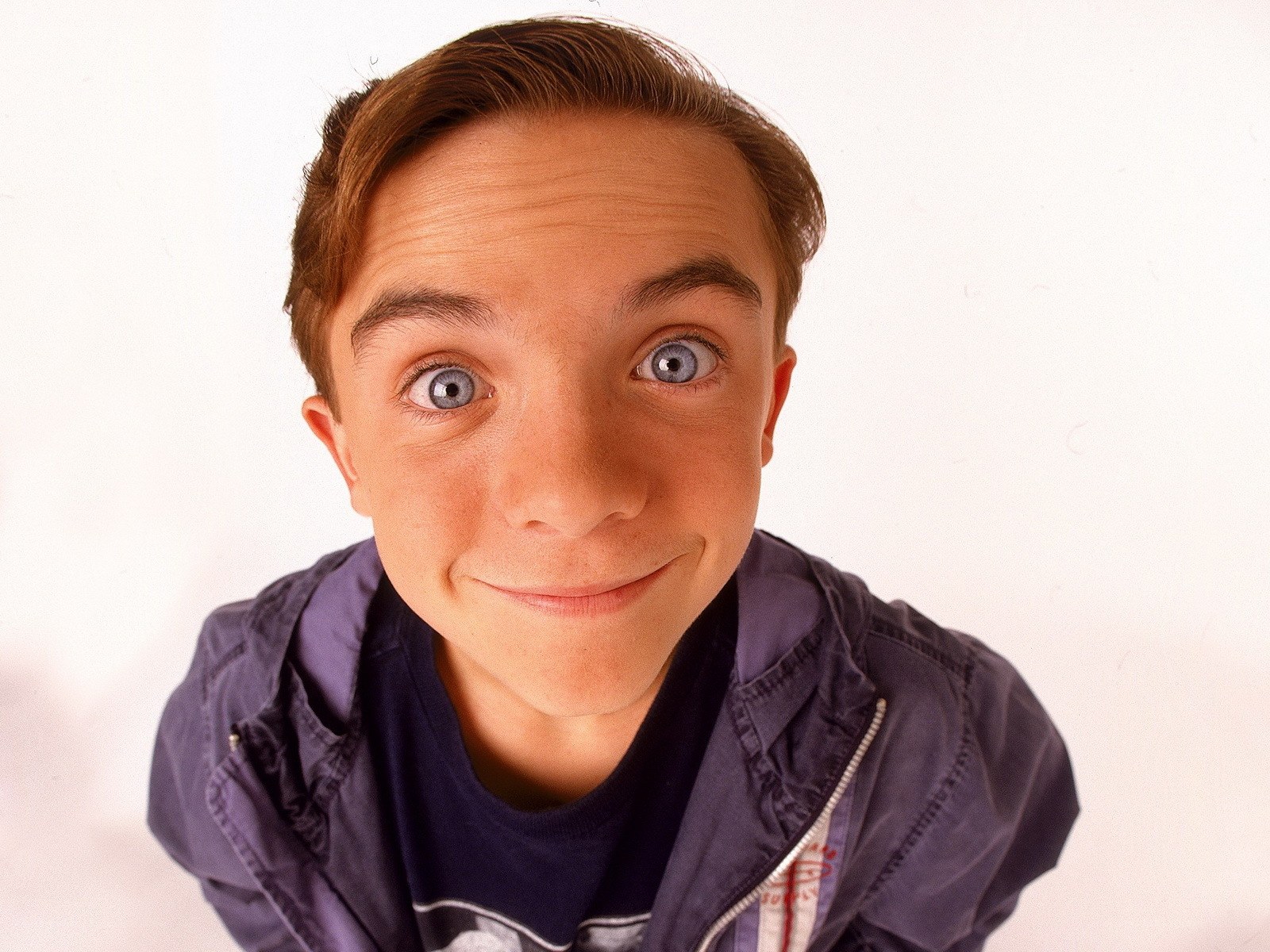 boy with wide eyes smiling