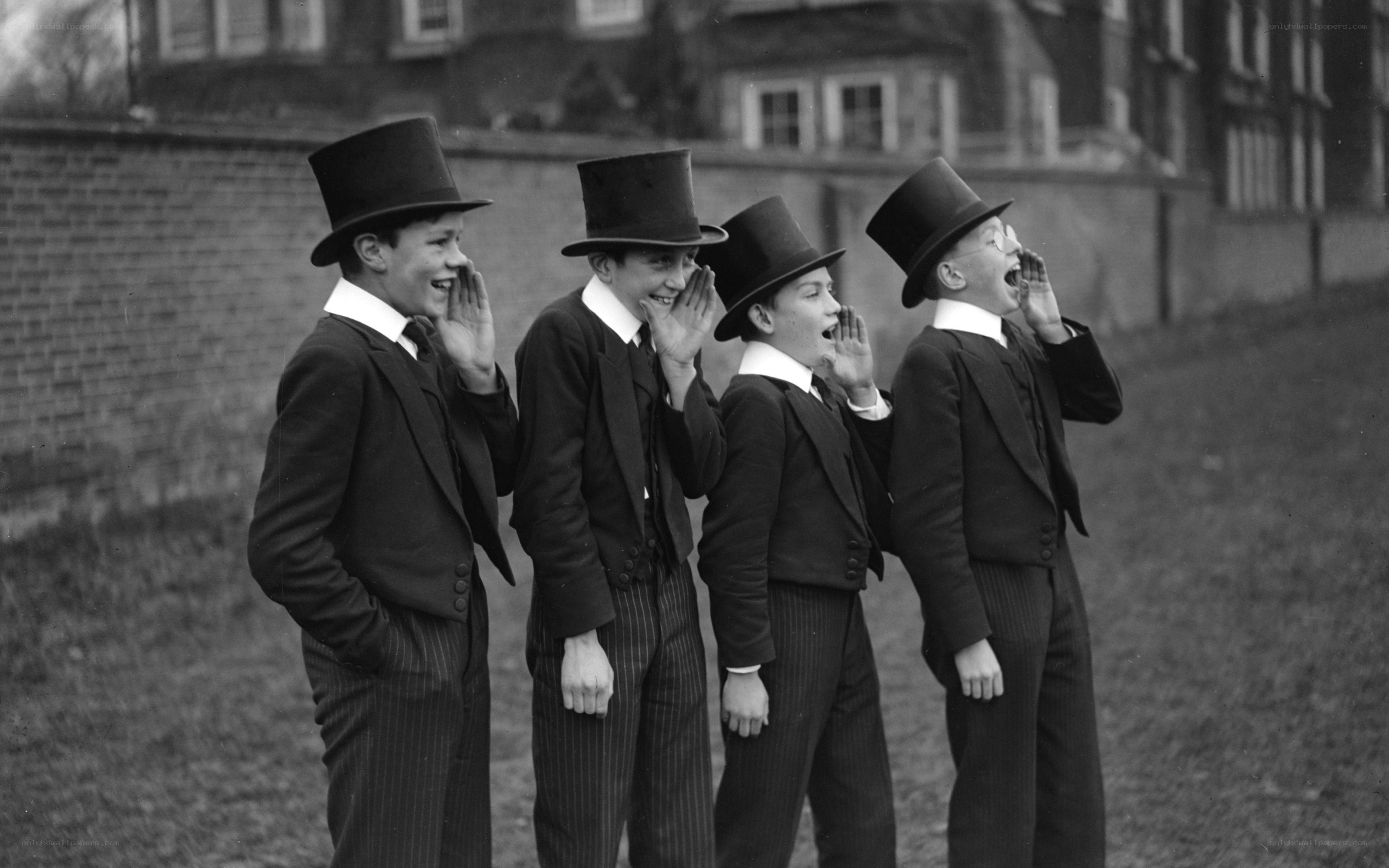 Boys in top hats whispering