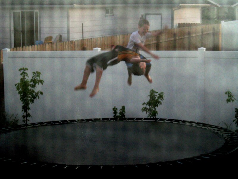boys jumping on trampoline