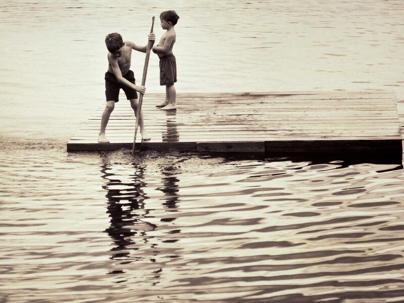 Boys on a dock with pole
