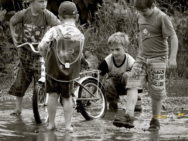 boys playing in a puddle