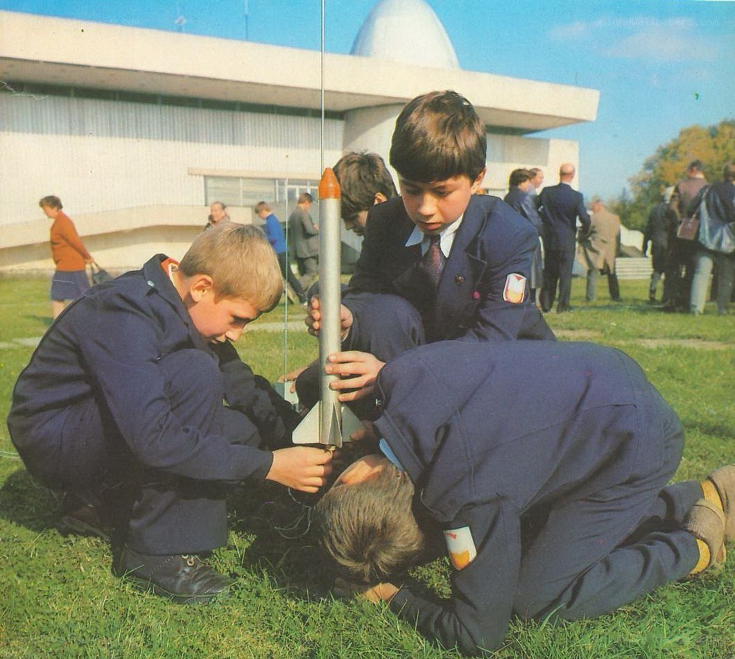 Boys preparing a model rocket