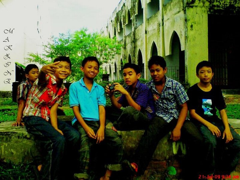 boys sitting on a wall