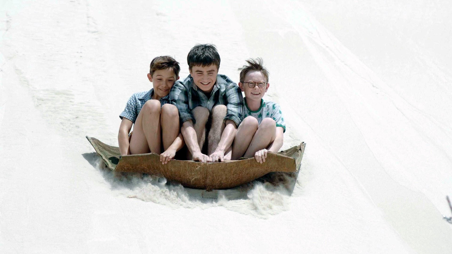 boys sliding on a sled