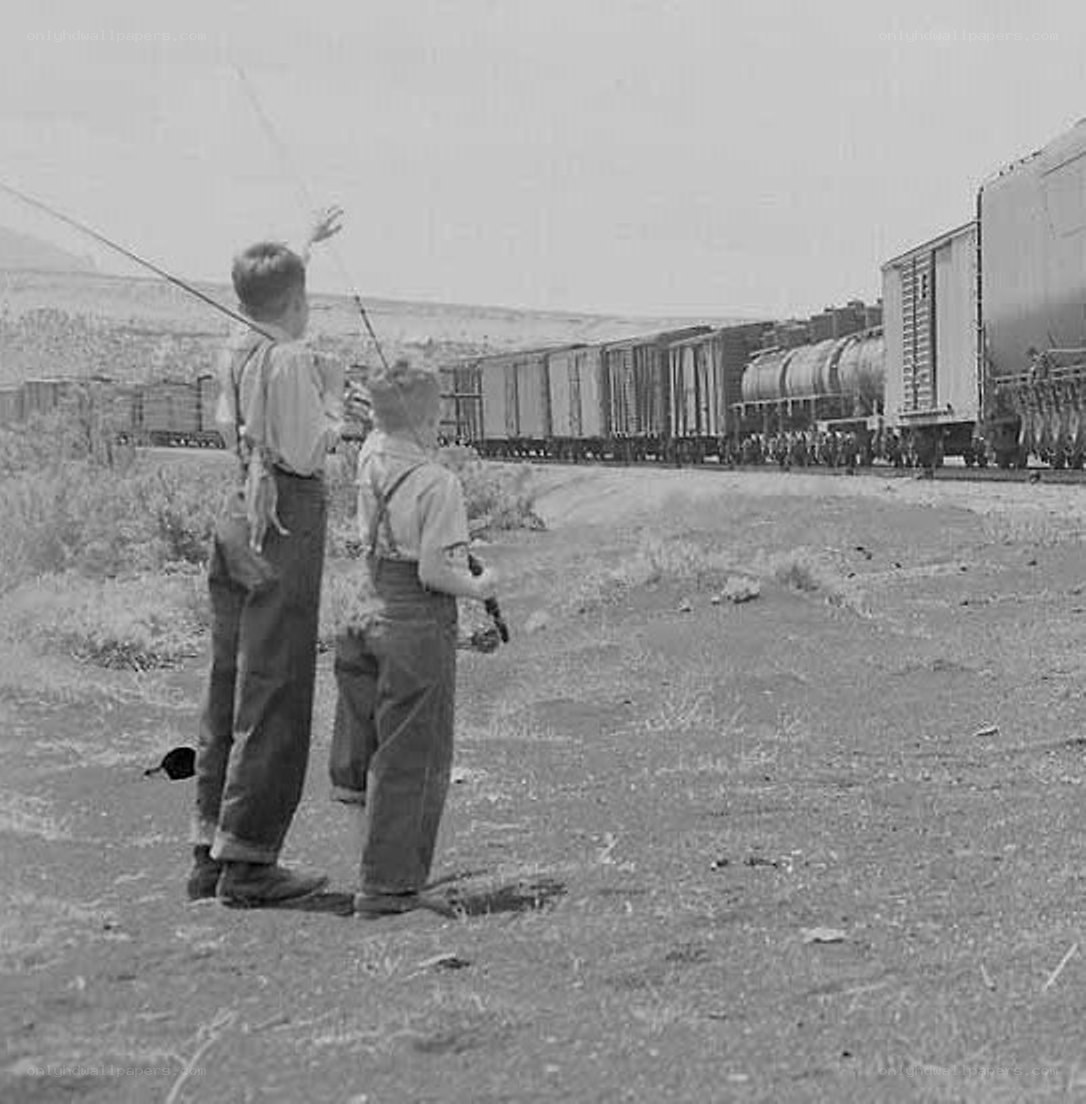 Boys watching a train pass by
