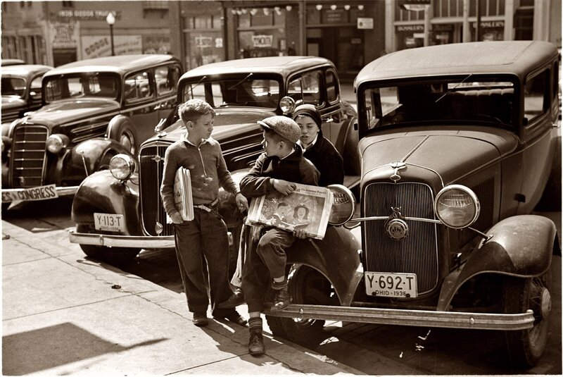 Boys with newspapers on street
