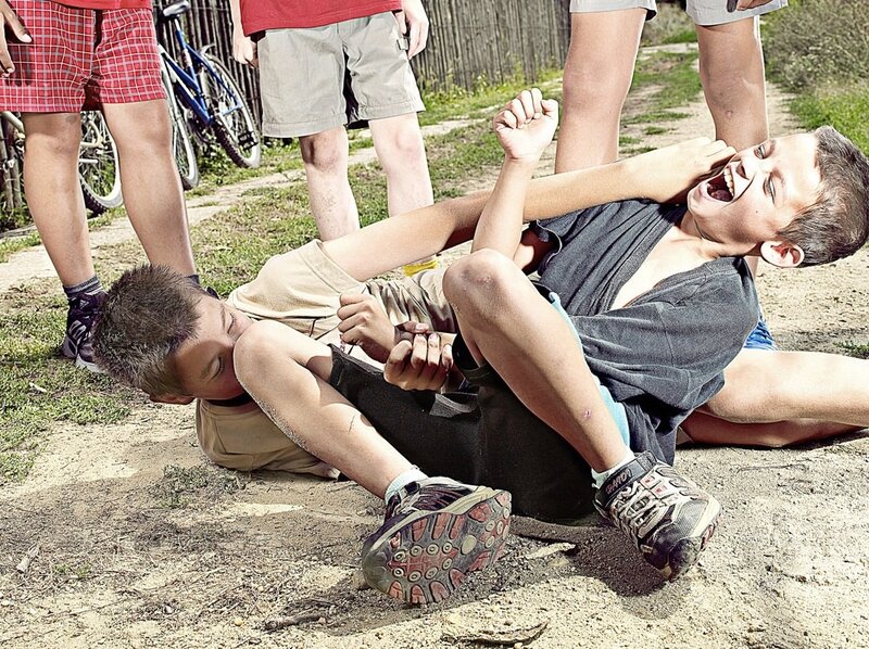 Boys wrestling on the ground