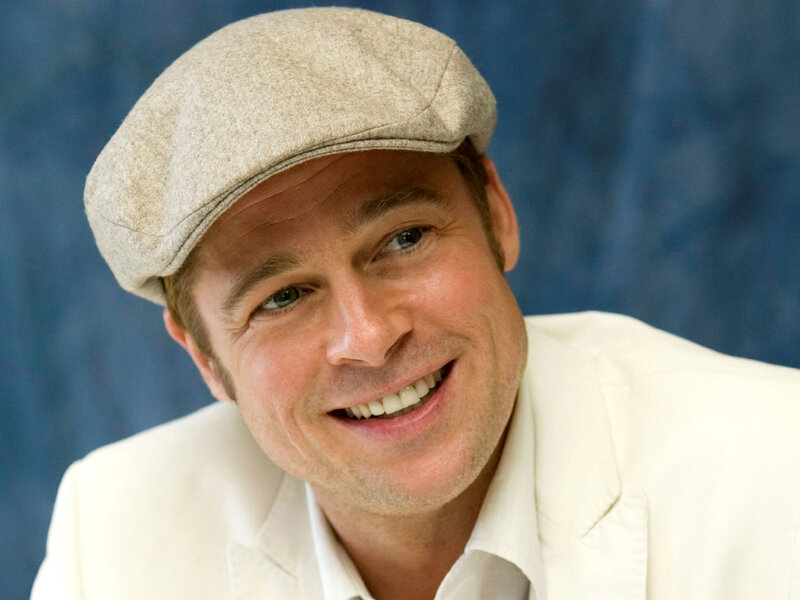 Brad Pitt smiling in a cap